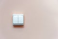 White electric switch on pink wall Royalty Free Stock Photo