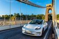 White electric Tesla car at Clifton Suspension Bridge in Bristol, UK Royalty Free Stock Photo