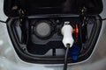 White electrical nozzle charging an e-car