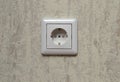 White electrical outlet on a light wall Royalty Free Stock Photo