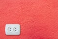 White electrical outlet socket on red wall Royalty Free Stock Photo