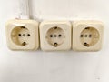 A white electrical outlet on the wall in the room. An electric plug with a cable in the socket Royalty Free Stock Photo