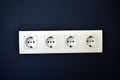 White electrical outlets on a blue wall with Internet connectors Royalty Free Stock Photo