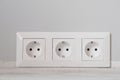 White electrical outlets with frame on gray wall background Royalty Free Stock Photo