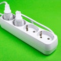 White Electrical Power Strip on a Green Background Royalty Free Stock Photo
