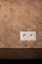 White electrical sockets in copper tile wall Royalty Free Stock Photo