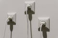 white electrical sockets with plugs in them. connecting high-voltage wire to the socket Royalty Free Stock Photo
