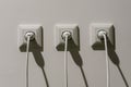 white electrical sockets with plugs in them. connecting high-voltage wire to the socket Royalty Free Stock Photo