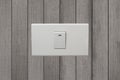 White electrical switch on wooden wall. Royalty Free Stock Photo