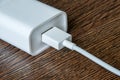 White electrical usb cord and charger plug in wall outlet Royalty Free Stock Photo