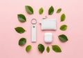 White electronic devices surrounded by green leaves on a pink background Royalty Free Stock Photo