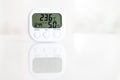 White electronic hygrometer on white table Royalty Free Stock Photo