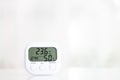 White electronic hygrometer on white table Royalty Free Stock Photo