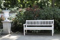 white elegant wooden bench in beautiful flowering blooming garden Royalty Free Stock Photo