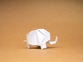 A white elephant paper standing isolated on eco brown kraft paper background. Royalty Free Stock Photo