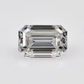A white emerald cut diamond is sitting on a white background Royalty Free Stock Photo