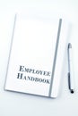 White Employee Handbook or manual with White pen on a white table in an office. Royalty Free Stock Photo