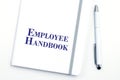 White Employee Handbook or manual with White pen on a white table in an office. Royalty Free Stock Photo