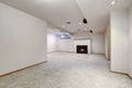 White empty basement room with fireplace