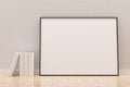 White empty blank picture or poster frame template mock up design standing on wooden floor with white wall background in room with Royalty Free Stock Photo