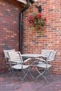 White Empty Cafe Table and Chairs in Corner in front of Brick Wall Royalty Free Stock Photo