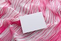 White empty card on the soft pink fabric background.Concept of new collection presentation Royalty Free Stock Photo