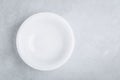 White empty ceramic plate on gray concrete or stone background Royalty Free Stock Photo