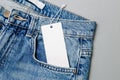 White empty clothing tag, label blank mockup for design on a jeans Royalty Free Stock Photo