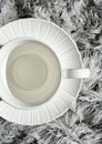 White empty coffee cup on a white winter scarf Royalty Free Stock Photo