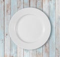 White empty dinner plate on blue wooden table Royalty Free Stock Photo