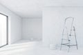 White empty hall for repairs, bucket of wall paint on the floor and stairs Royalty Free Stock Photo