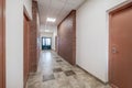 white empty long corridor with red brick walls in interior of modern apartments, office or clinic Royalty Free Stock Photo