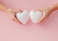 White empty love hearts in hands on pink background