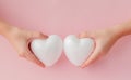 White empty love hearts in hands on pink background