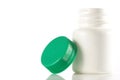 White empty medicine bottle standing with the cap at side Royalty Free Stock Photo