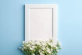 White empty photo frame mockup with mouse-ear chickweed flowers on blue background Royalty Free Stock Photo