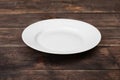 White empty plate on dark wooden table Royalty Free Stock Photo