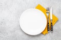 White empty plate, fork, knife and napkin Royalty Free Stock Photo