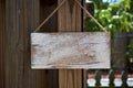 White empty rustic sign hanging from wooden fence Royalty Free Stock Photo