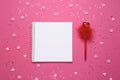 White empty sheet in notebook on a pink background with hearts next to the pen. Copy space. Place to your text. Valentine`s day, Royalty Free Stock Photo