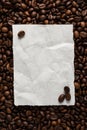 White empty sheet of paper on the background of roasted coffee beans for text menu or recipe Royalty Free Stock Photo