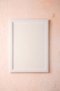 White empty template picture frame on textured bright, cream and peach background, top view