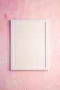 White empty template picture frame on textured bright, pink and peach background, top view