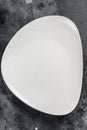 White empty triangular plate, restaurant background. Black background. Top view. Copy space