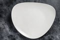 White empty triangular plate, restaurant background. Black background. Top view. Copy space