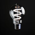 White energy saving bulb shines against sleek black background dramatically Royalty Free Stock Photo