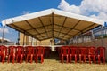 White entertainment tent with red plastic chairs Royalty Free Stock Photo