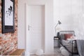 White entrance door to stylish bedroom interior, real photo with copy Royalty Free Stock Photo