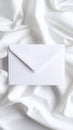 White Envelope on Elegant White Silk Fabric Background Royalty Free Stock Photo