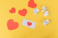 A white envelope lies with red hearts on a yellow background. Unsuccessful emails Royalty Free Stock Photo